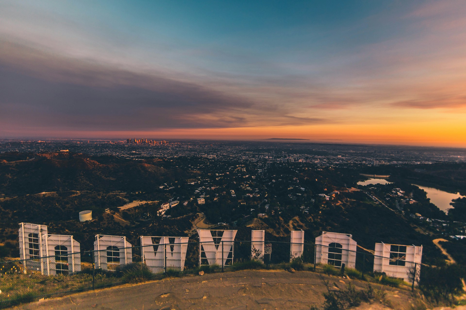Los Angeles at sunset seen from behind the Hollywood sign, the city many relocators rent in from afar.